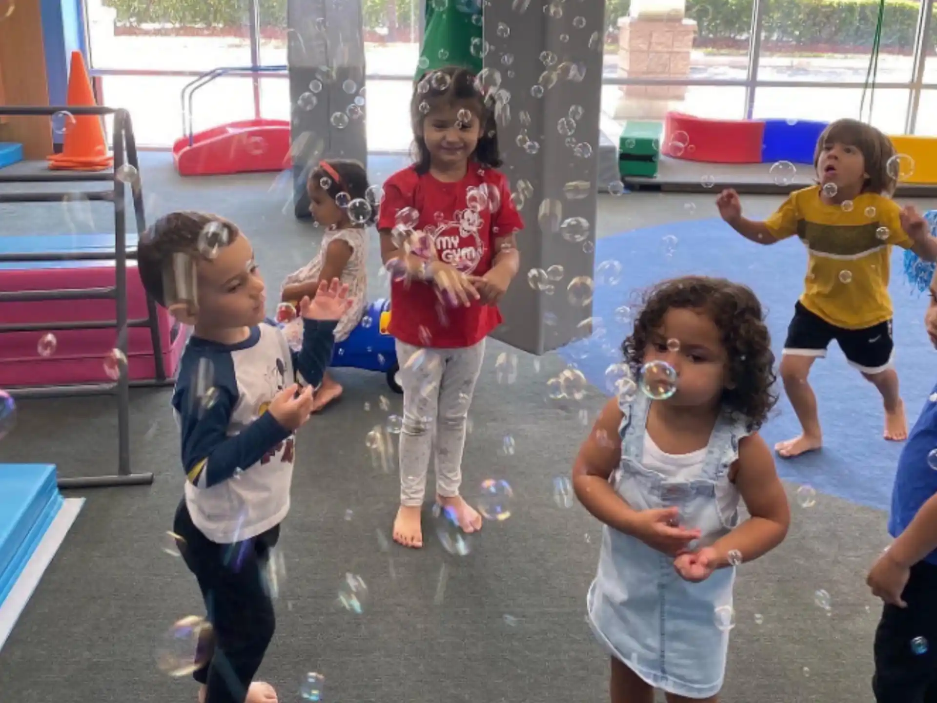 a group of children playing with bubbles
