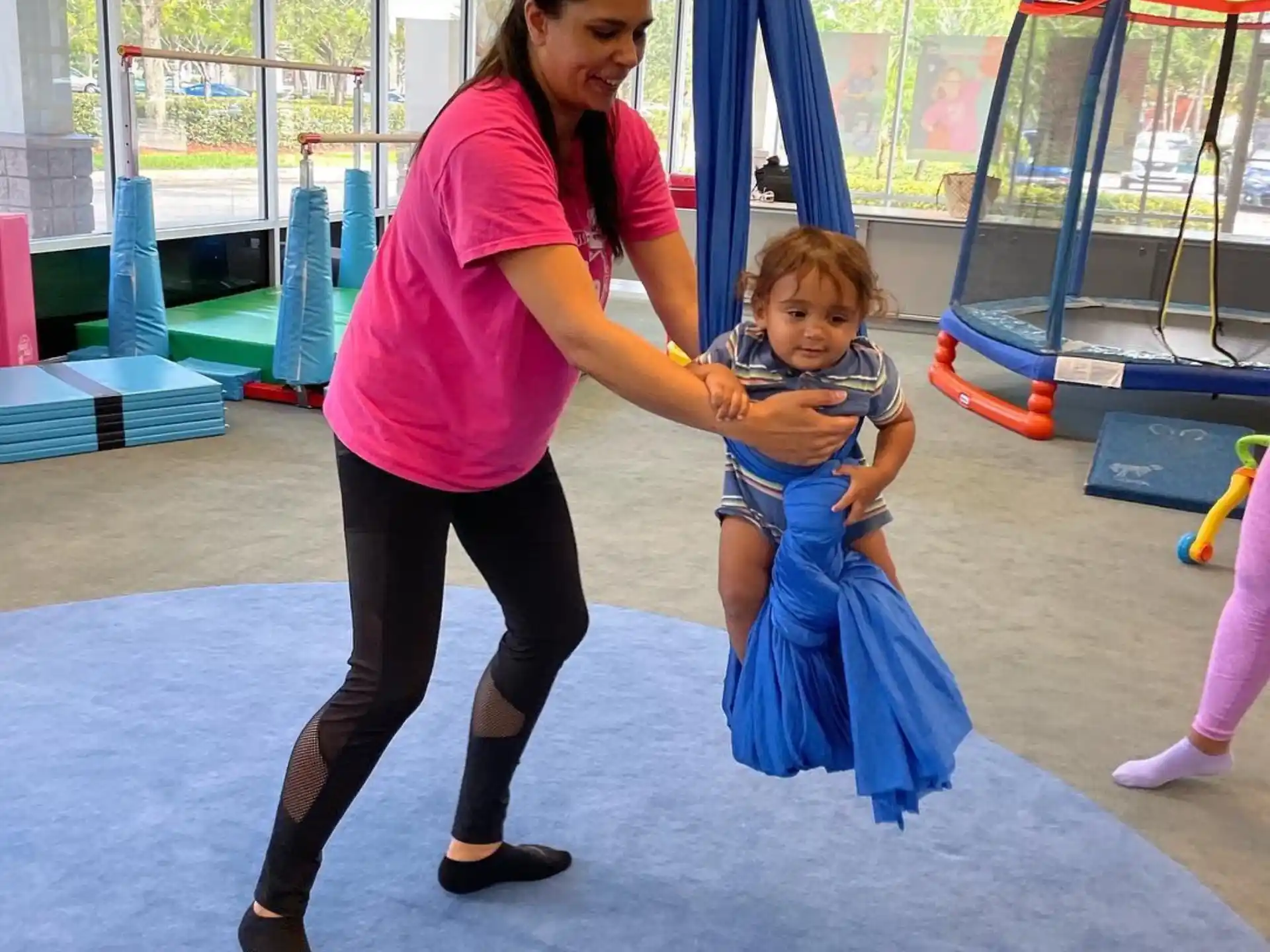 a person and a child in a gym