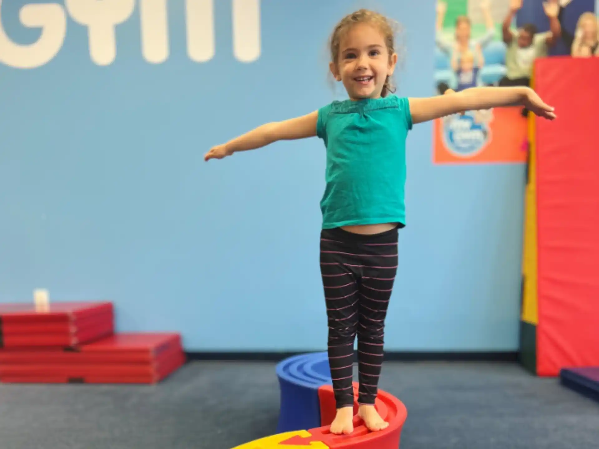 a girl standing on a toy