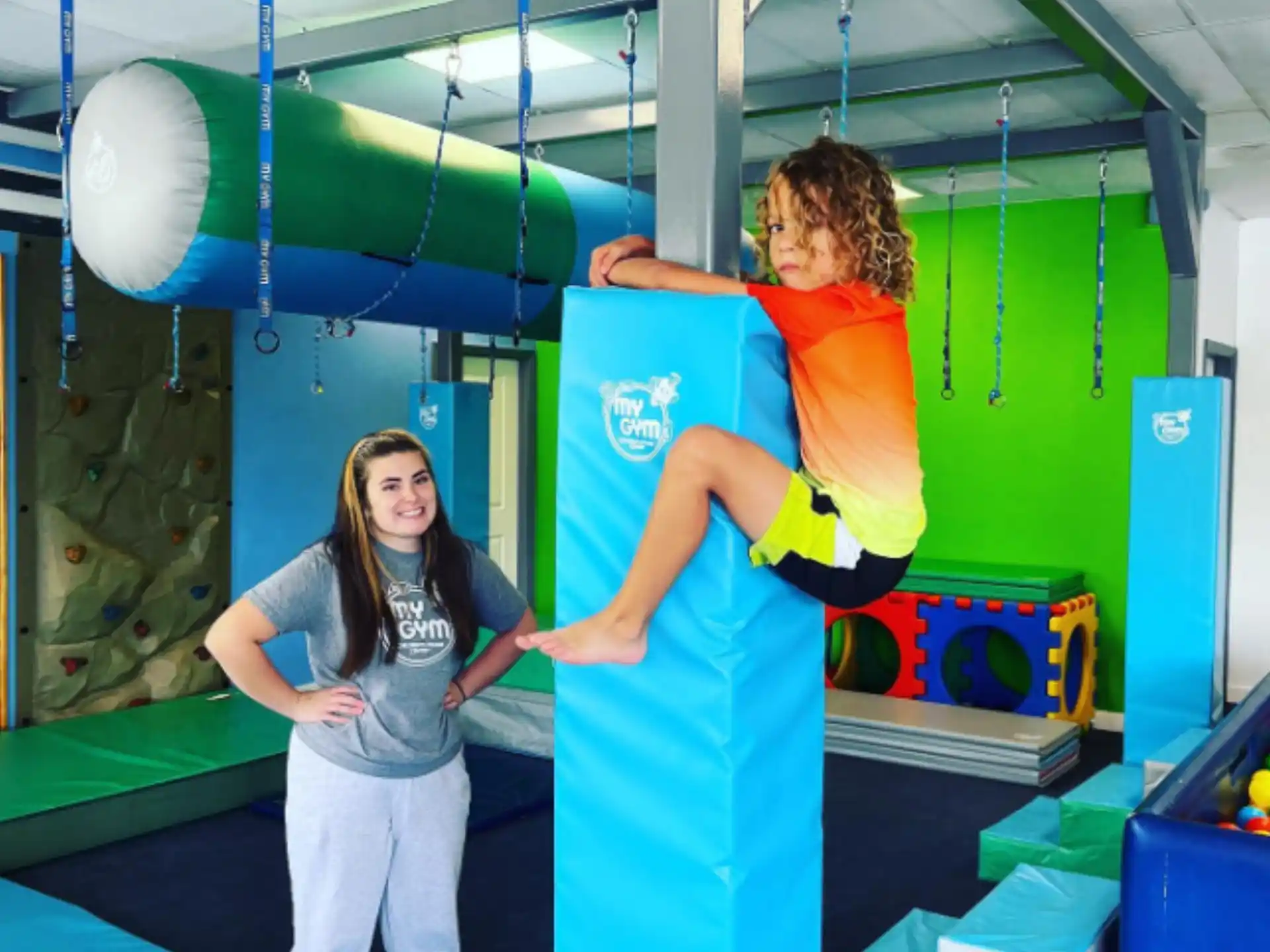 a person and a person in a room with a blue and yellow wall