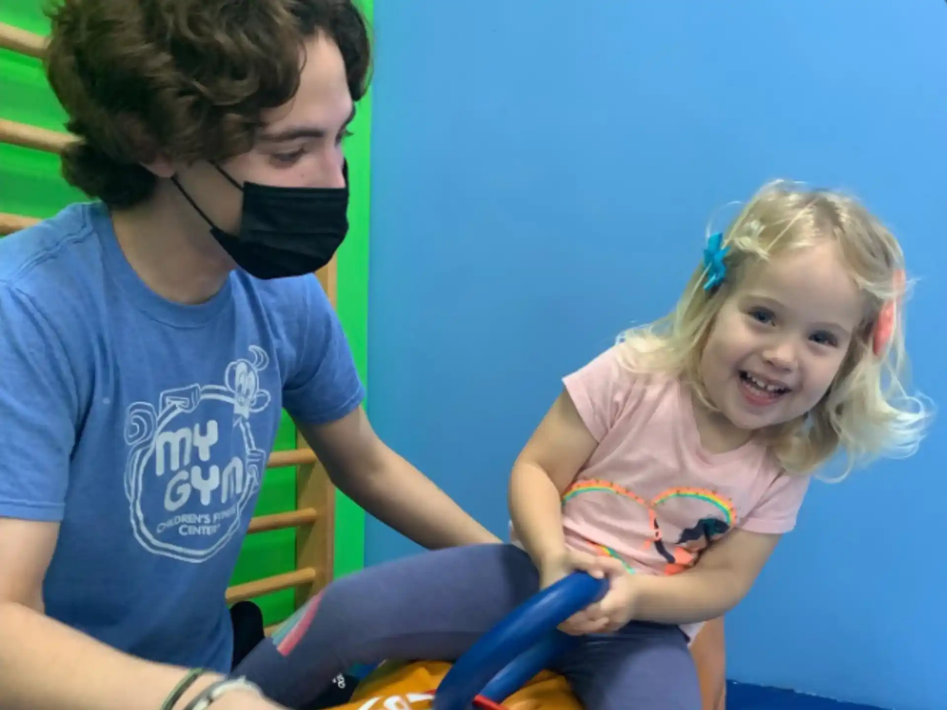 a person and a girl playing with a toy