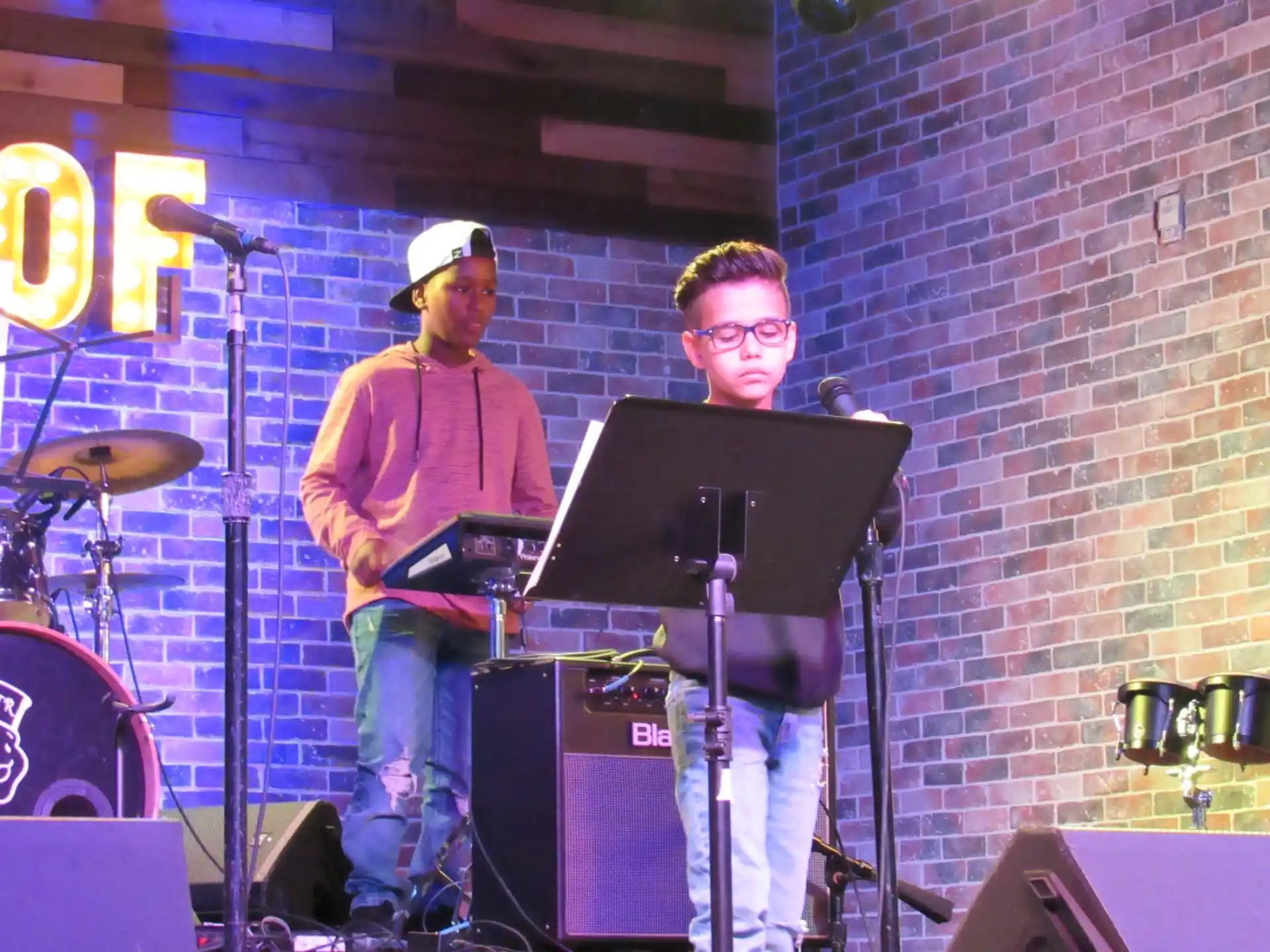 a couple of men on a stage with a laptop