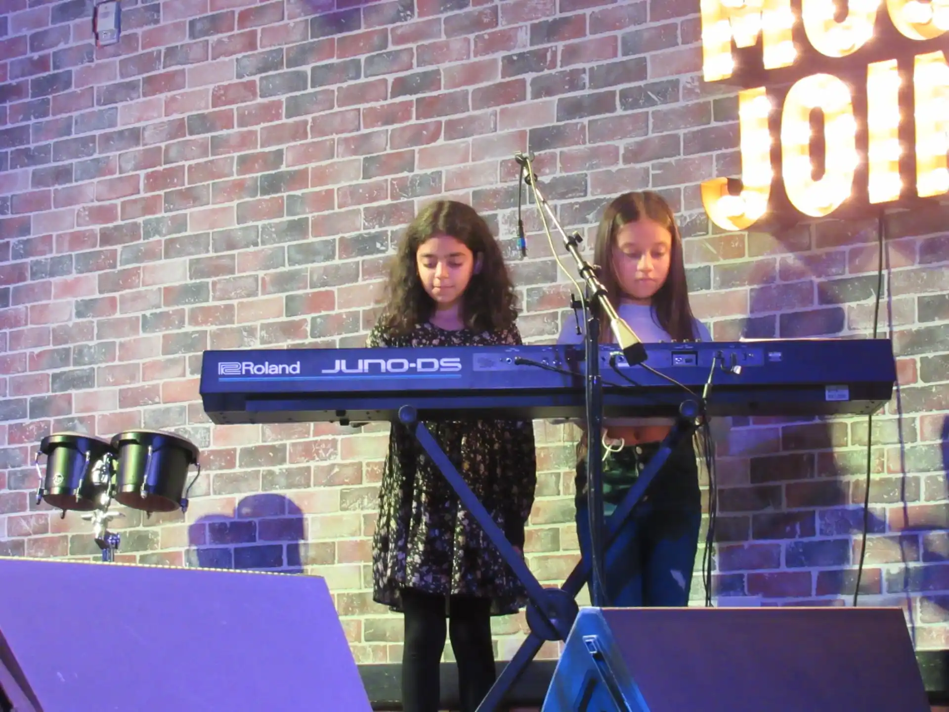 two women playing the piano