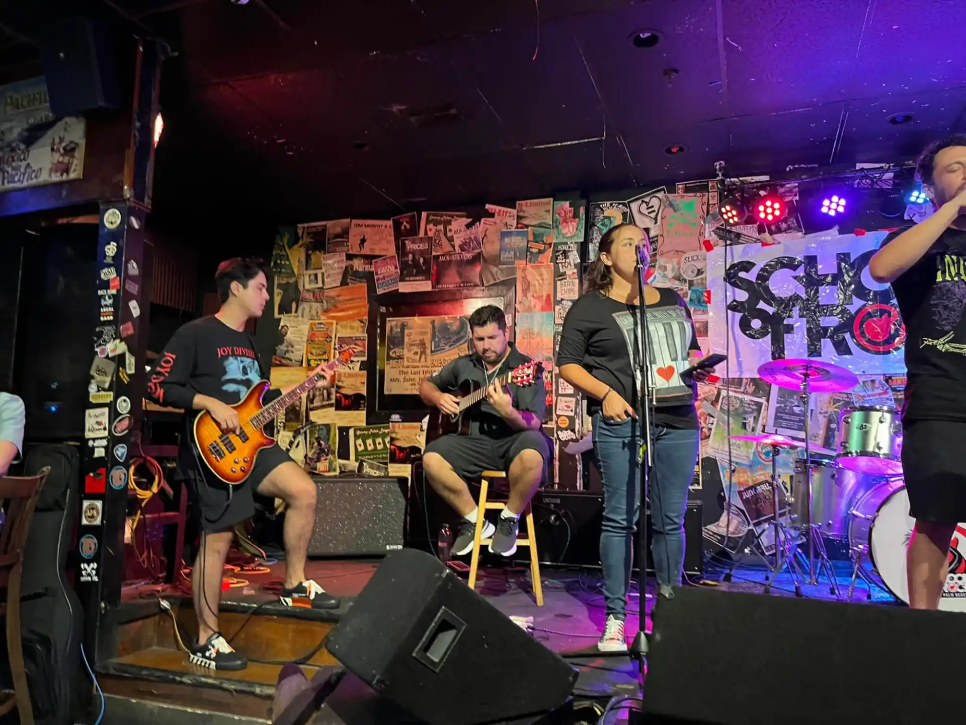 a group of people playing instruments on a stage