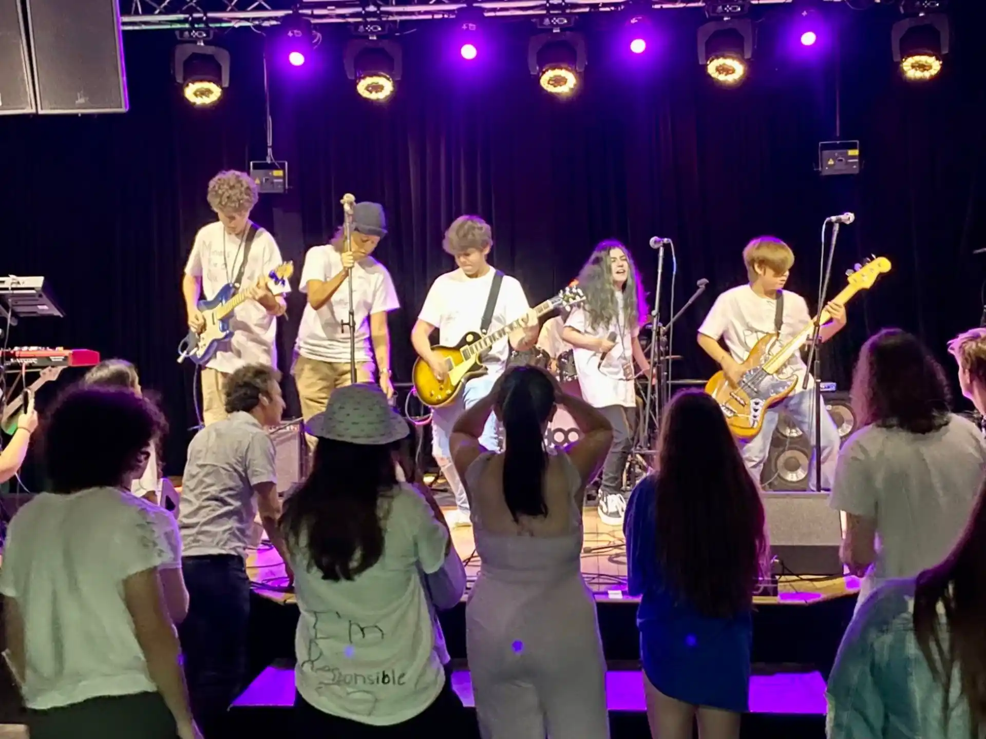 a group of people on a stage playing instruments