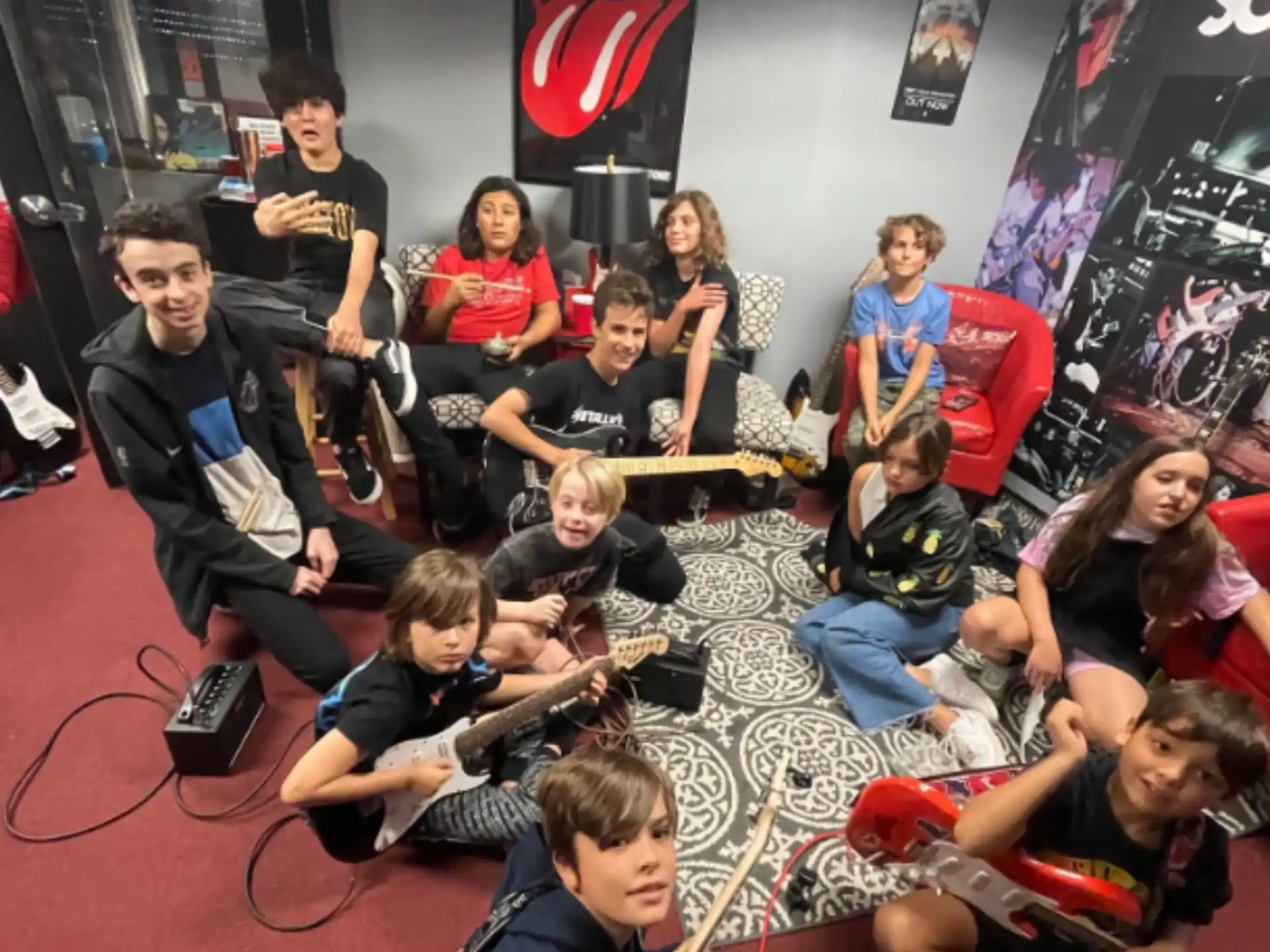 a group of people sitting on the floor with musical instruments