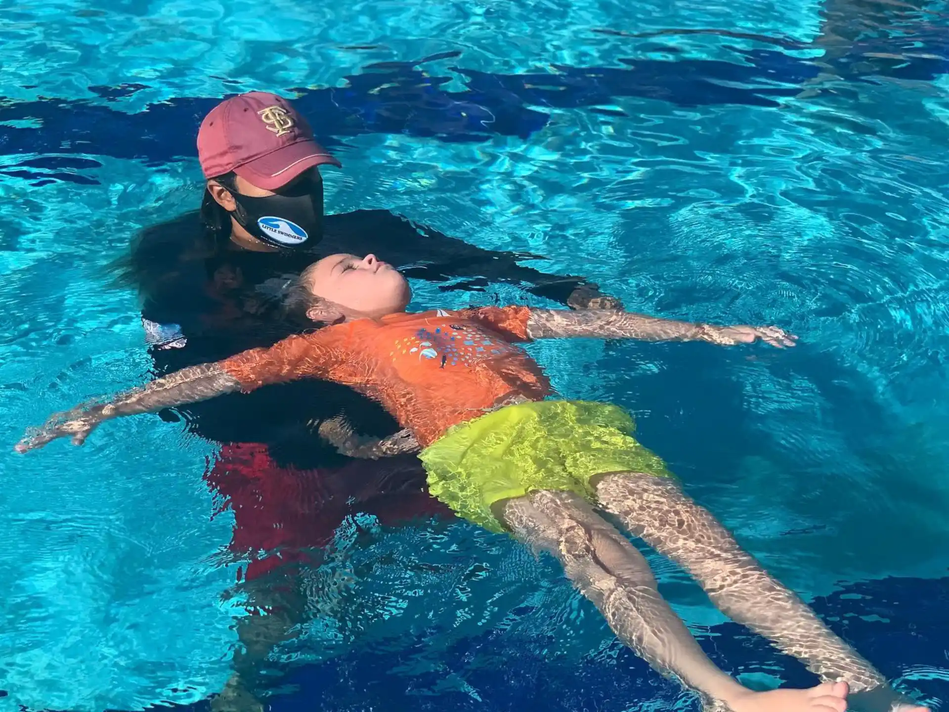 a man and a woman swimming in a pool