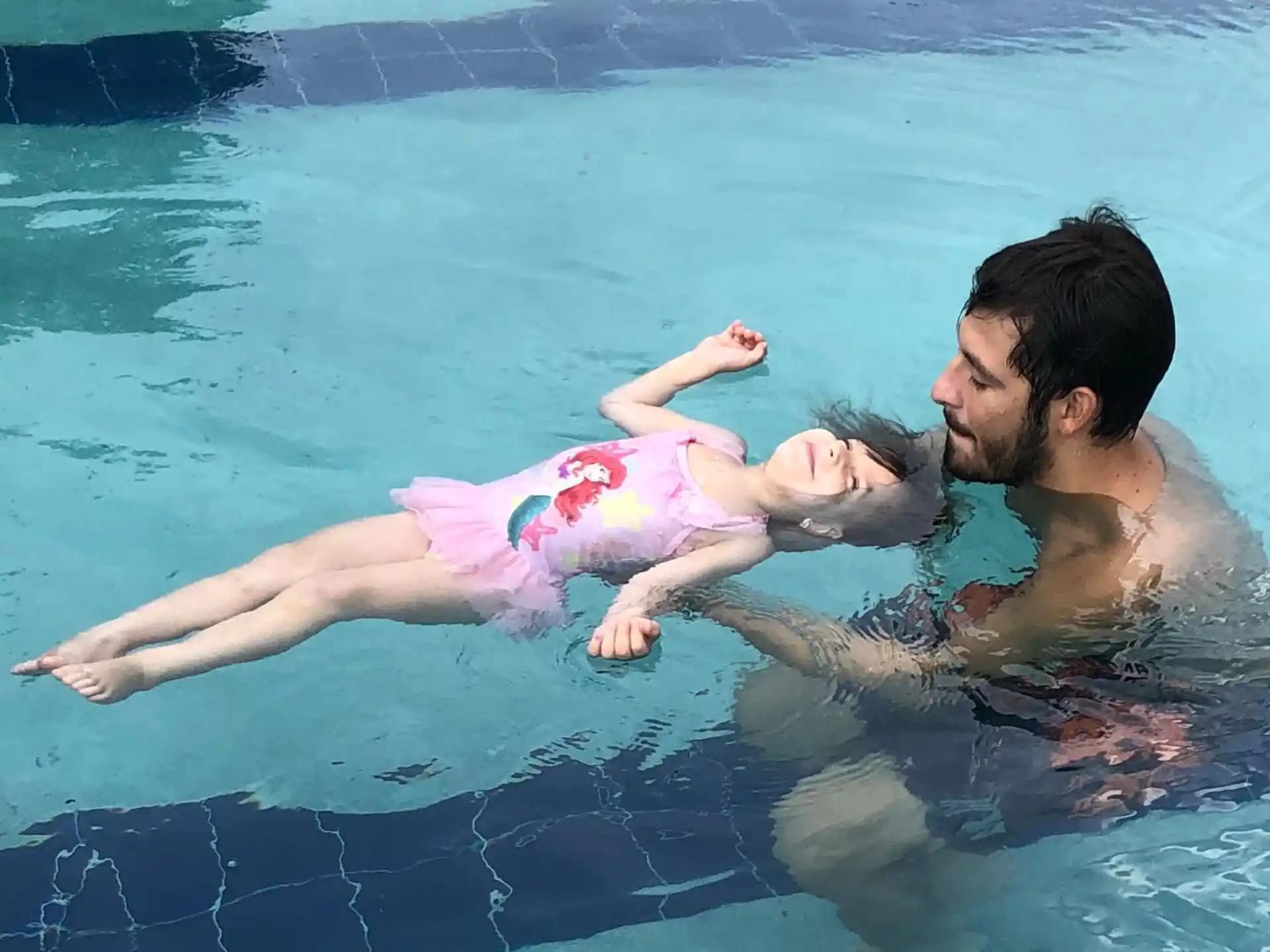 a person and a baby in a pool