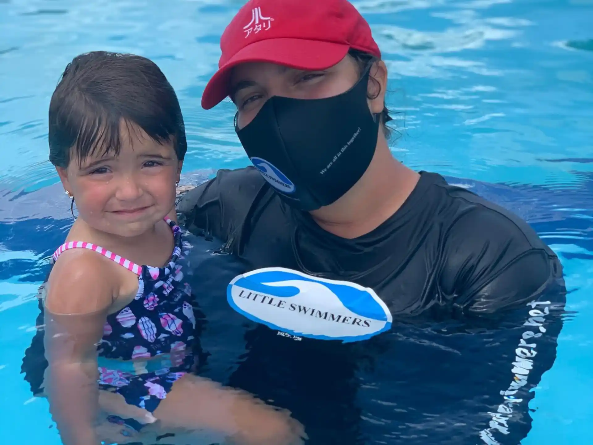 a person and a girl playing frisbee in the water