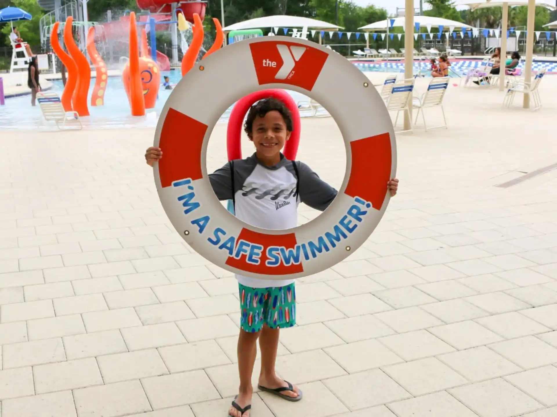 a boy holding a large red and white sign