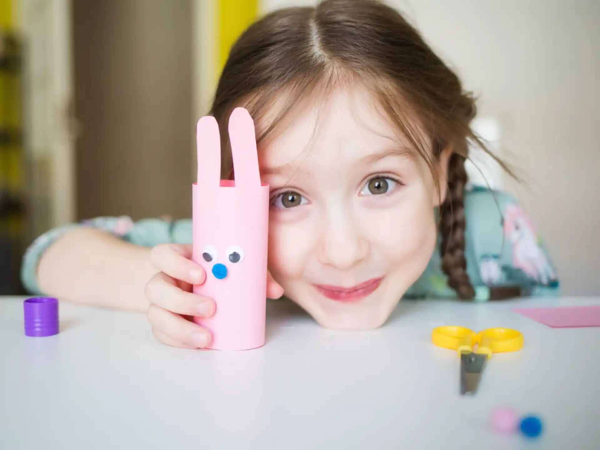 a girl holding a pink phone