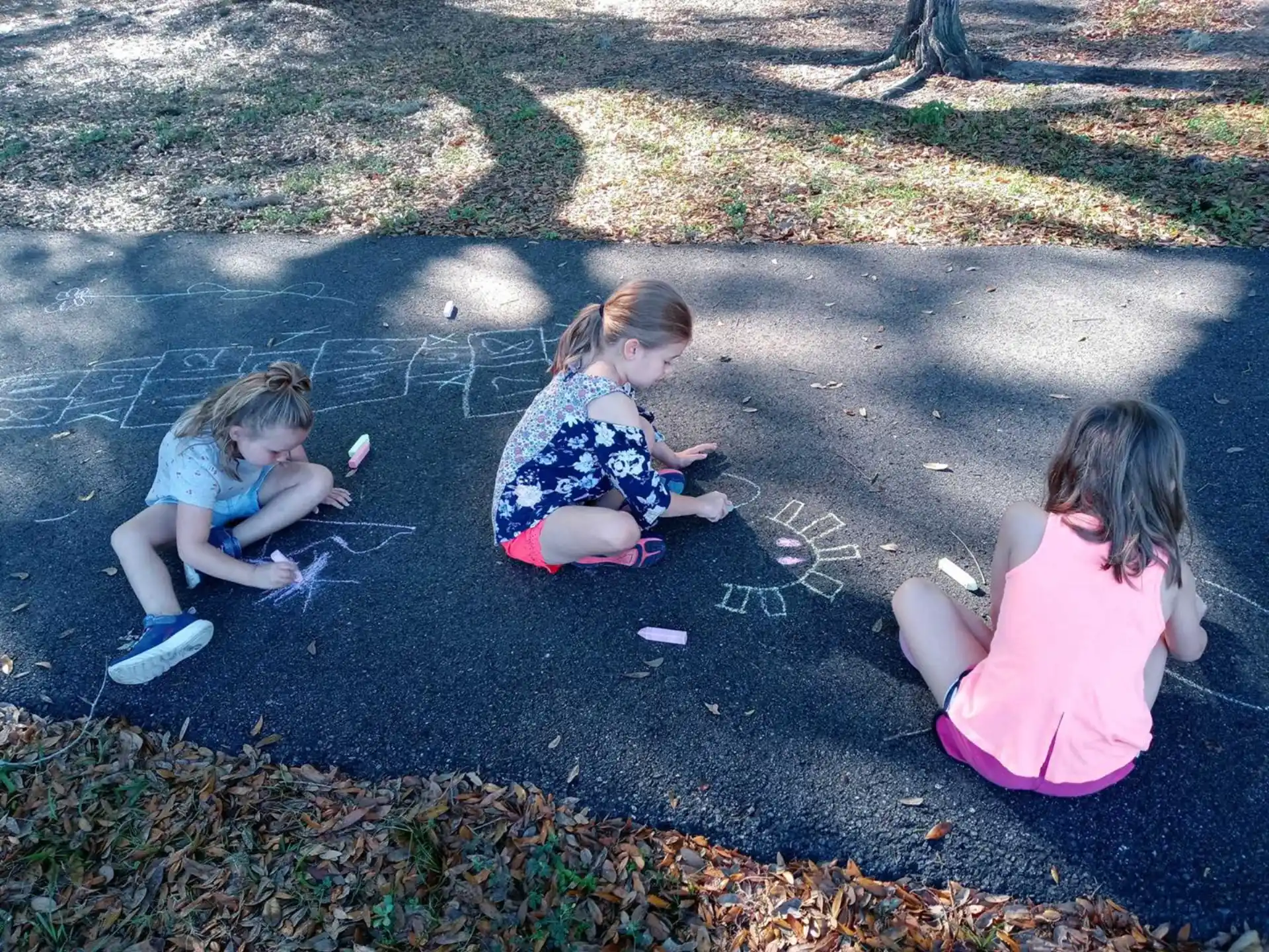 a group of girls sitting on the ground