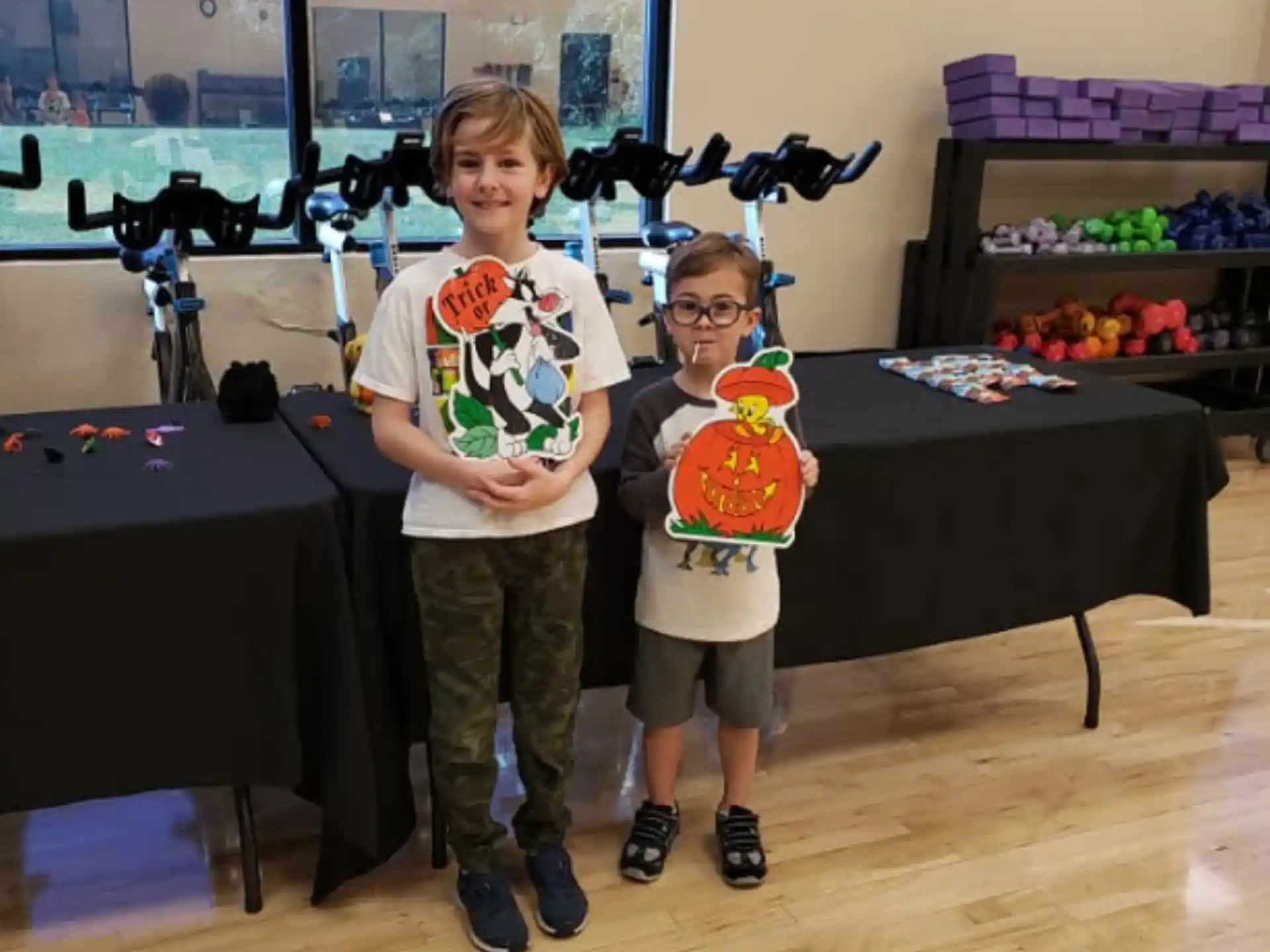 a couple of children holding up a large piece of paper