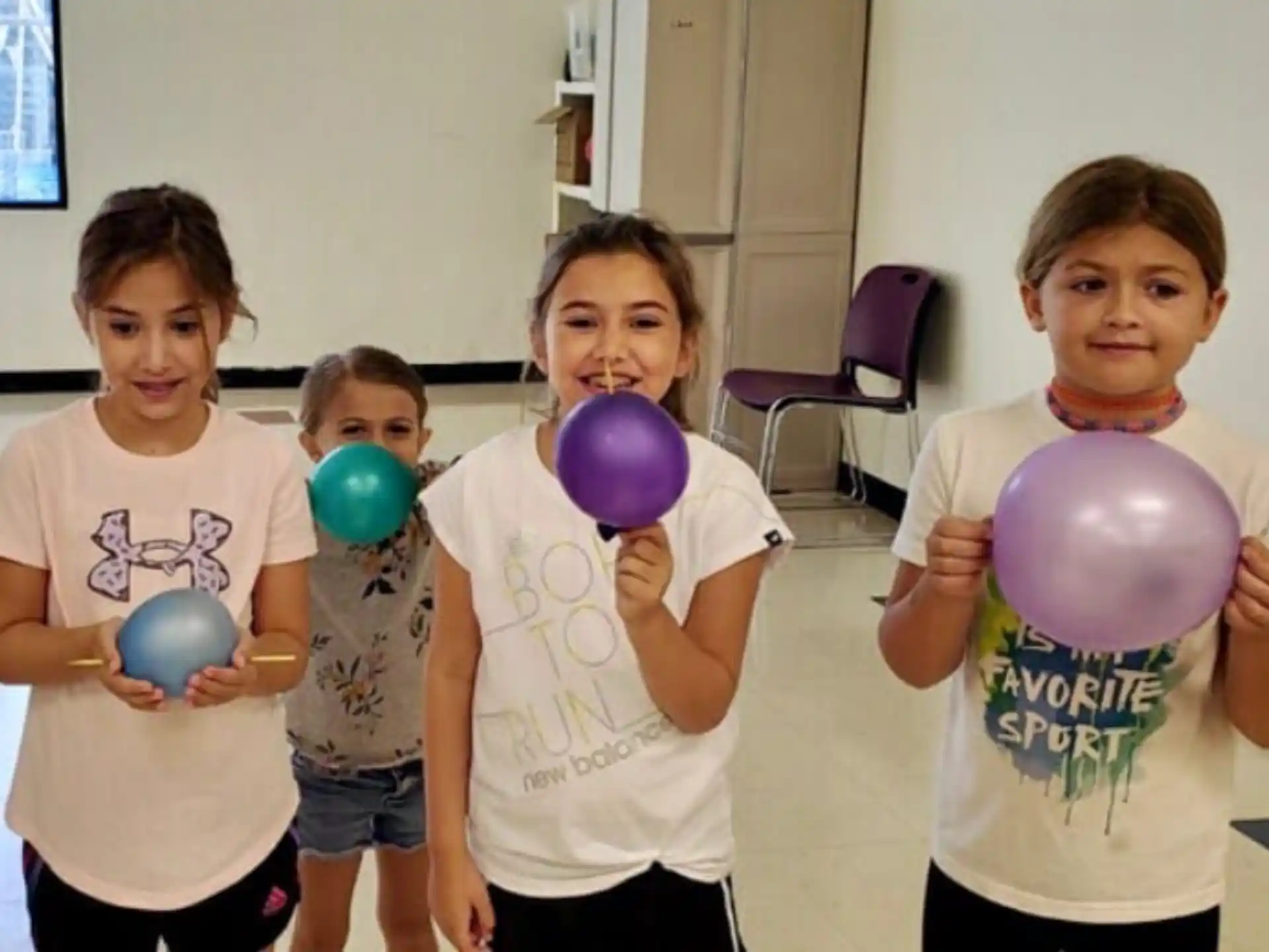 a group of kids holding balloons