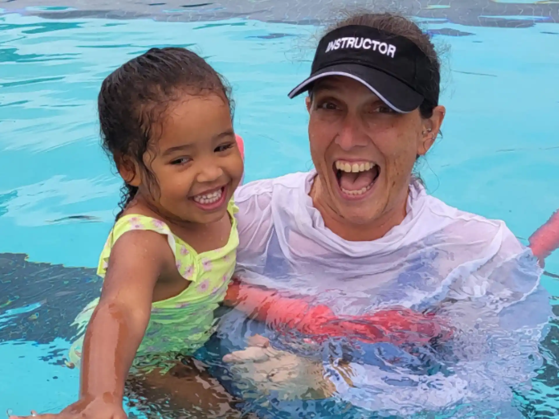 a person and a child in a pool