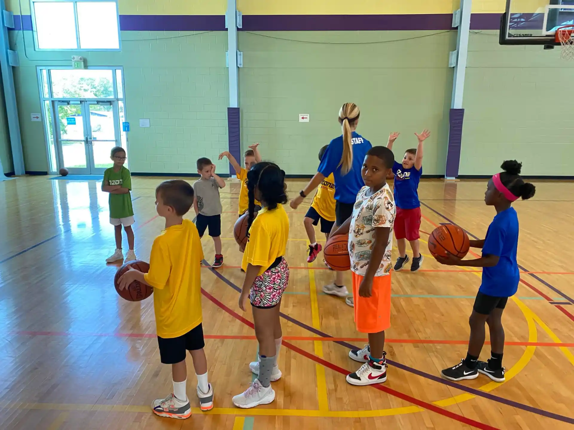 a group of kids playing basketball
