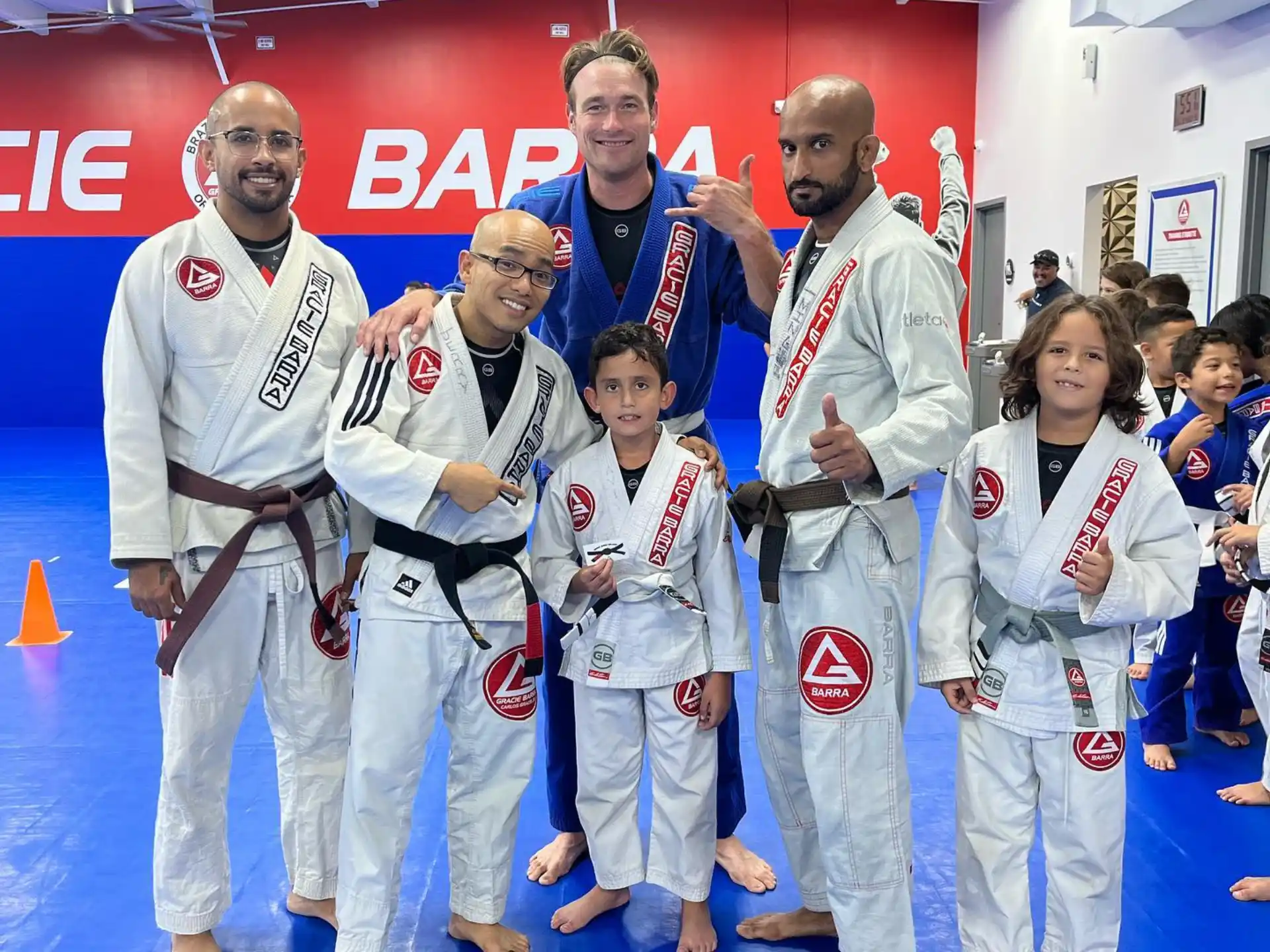 a group of people wearing white karate uniforms and posing for a photo