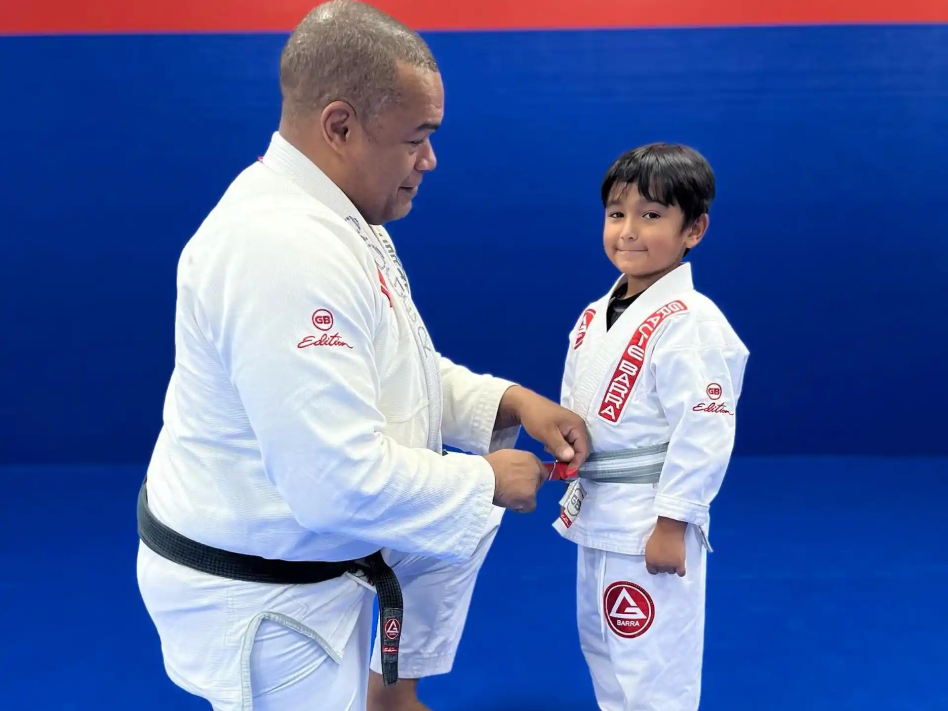a man and a boy in karate uniforms
