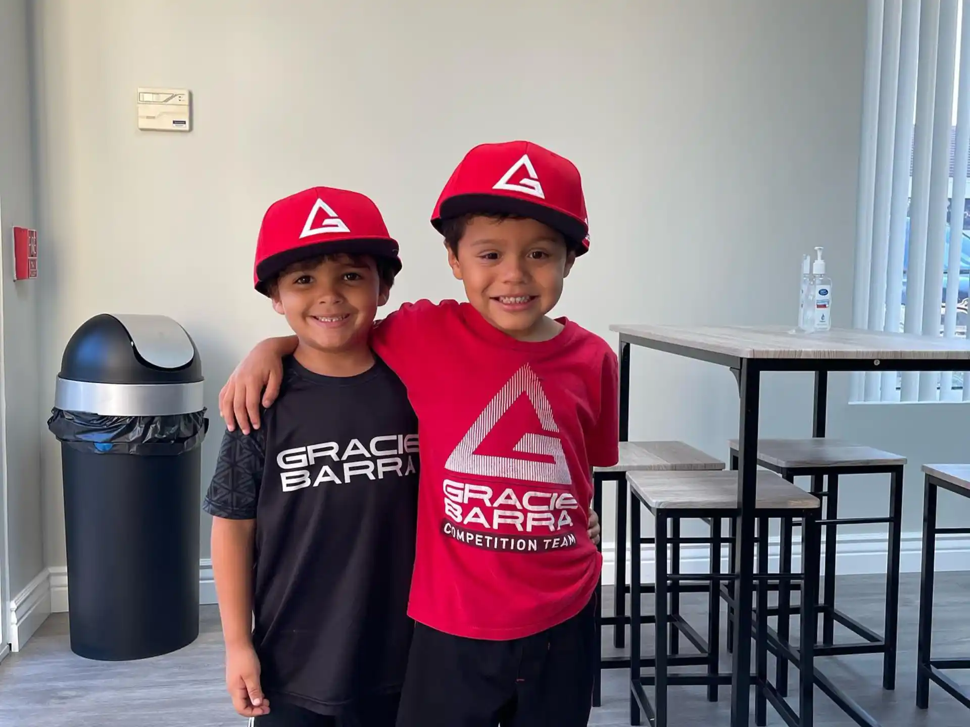 two boys wearing matching shirts