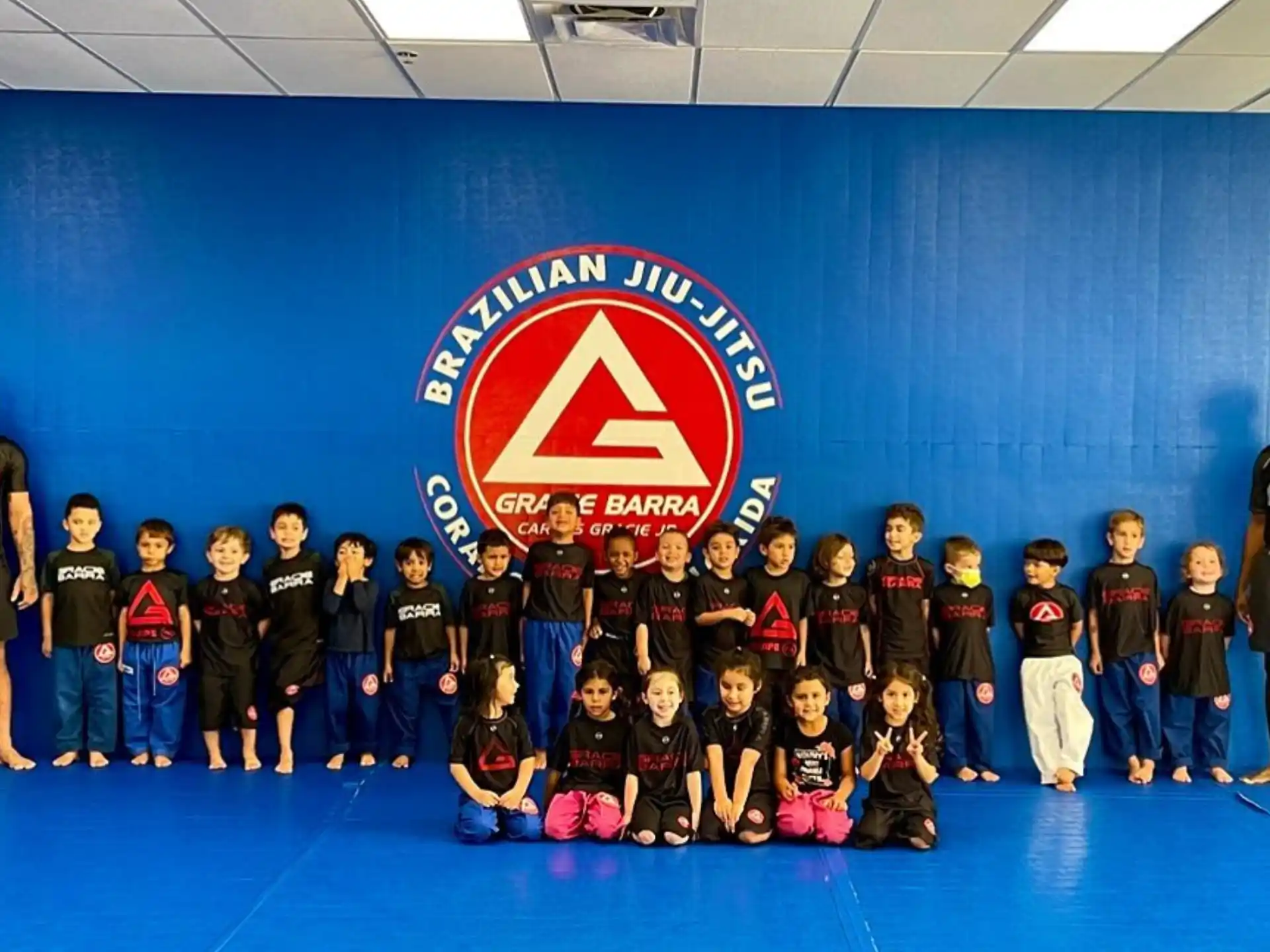 a group of children posing for a photo in front of a banner