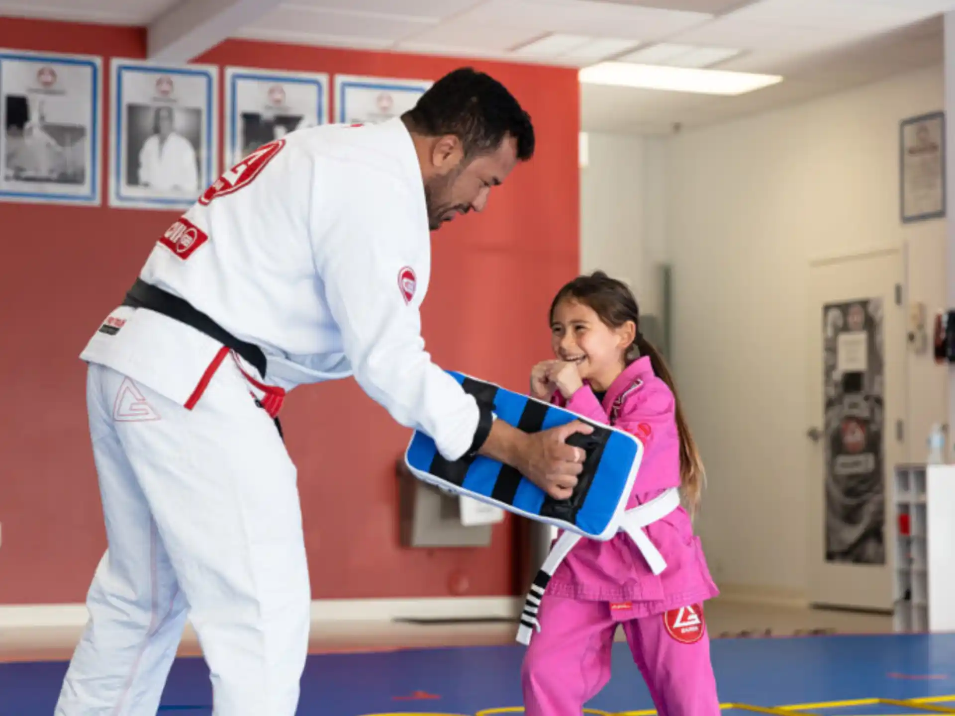 a man and a girl in karate uniforms