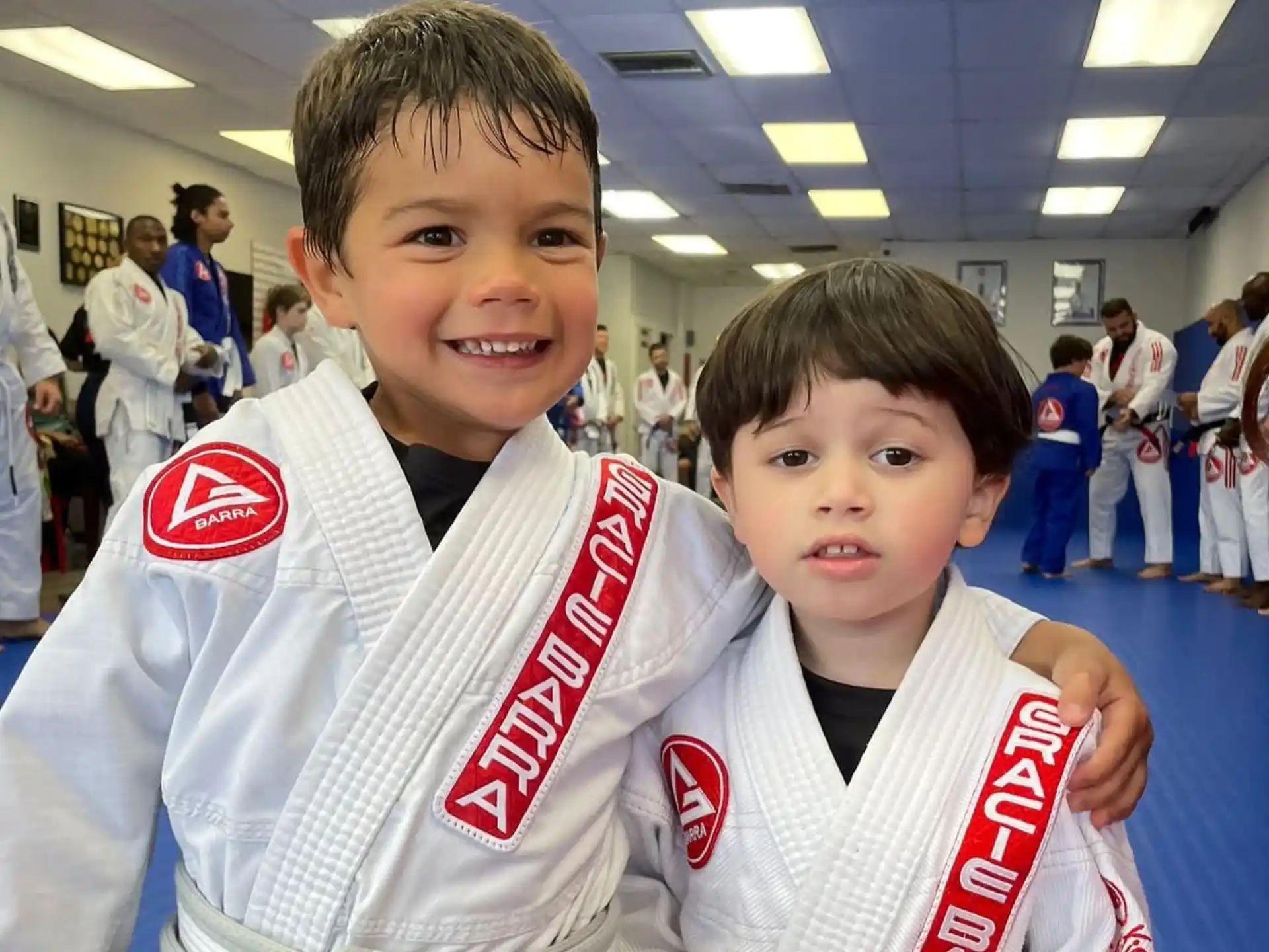a couple of boys in karate uniforms