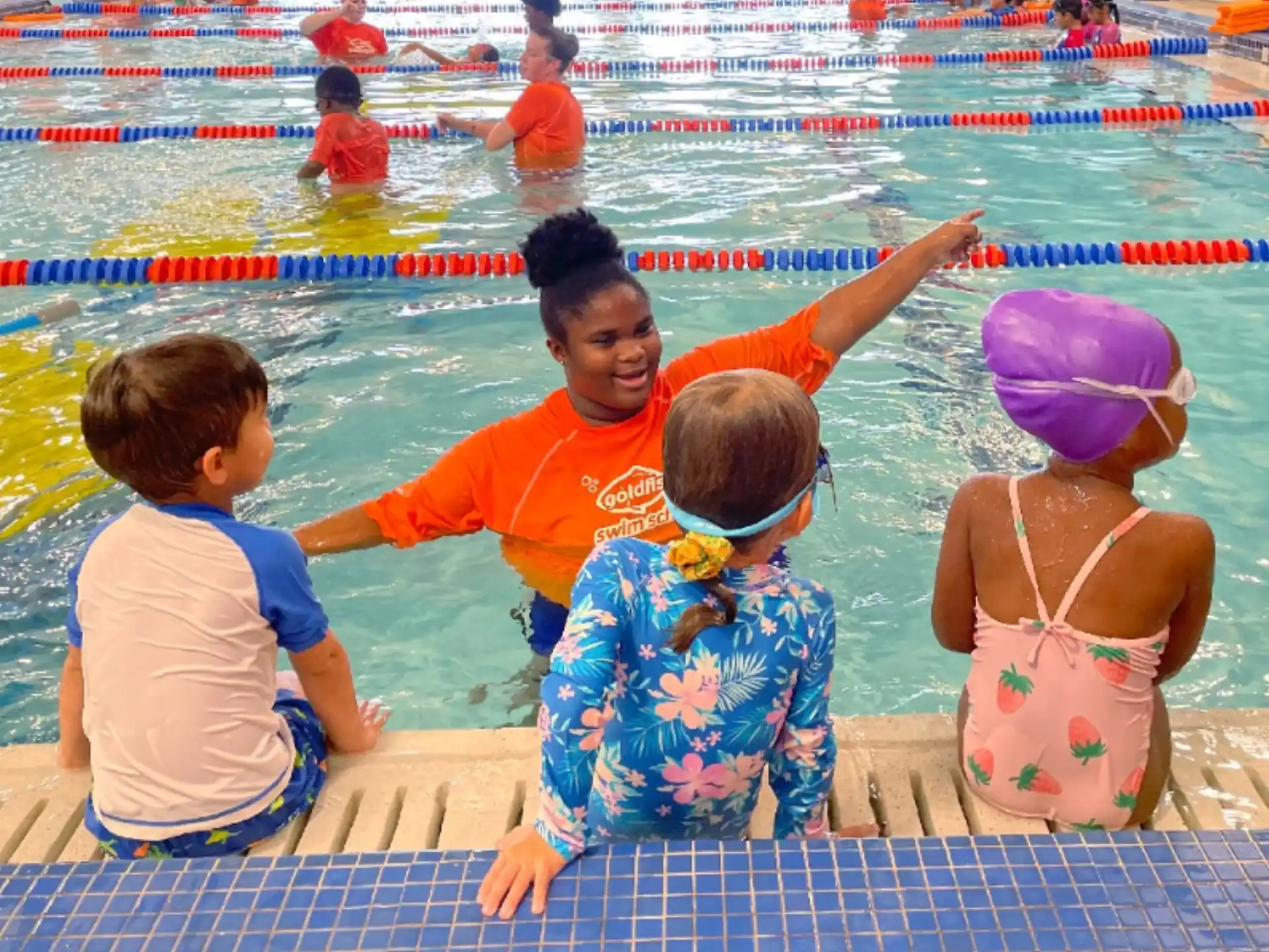 a man and kids in a pool