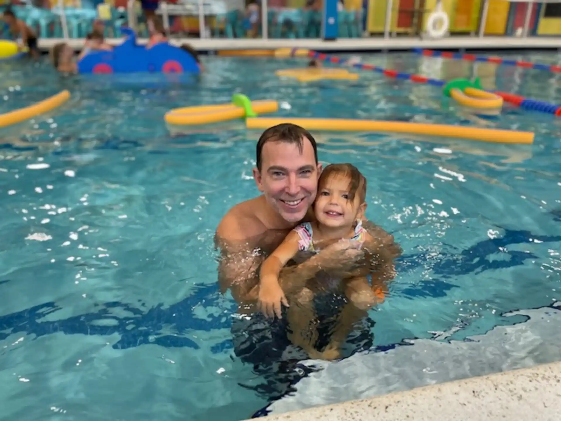 a person and a child in a pool