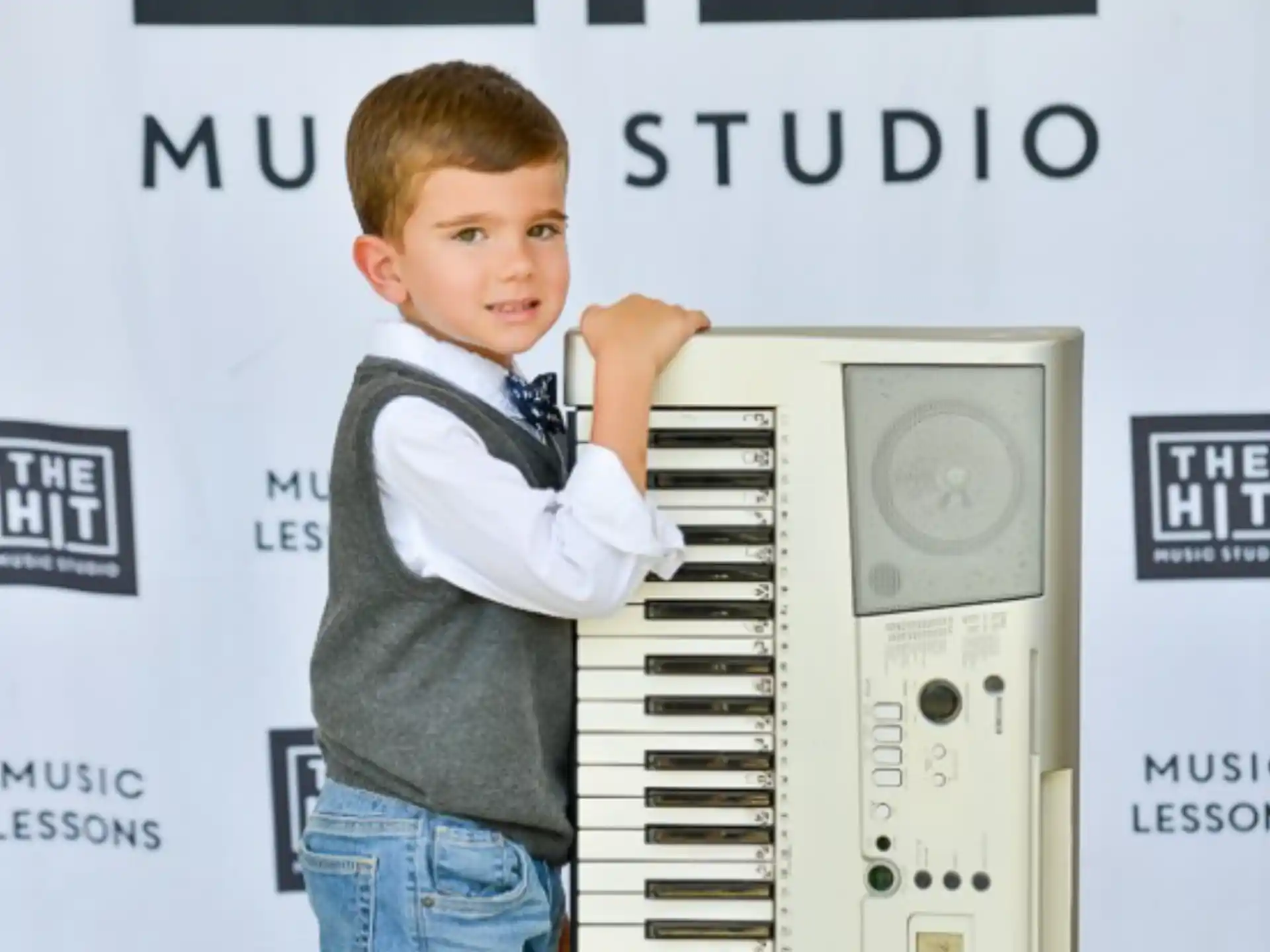 a boy standing next to a machine