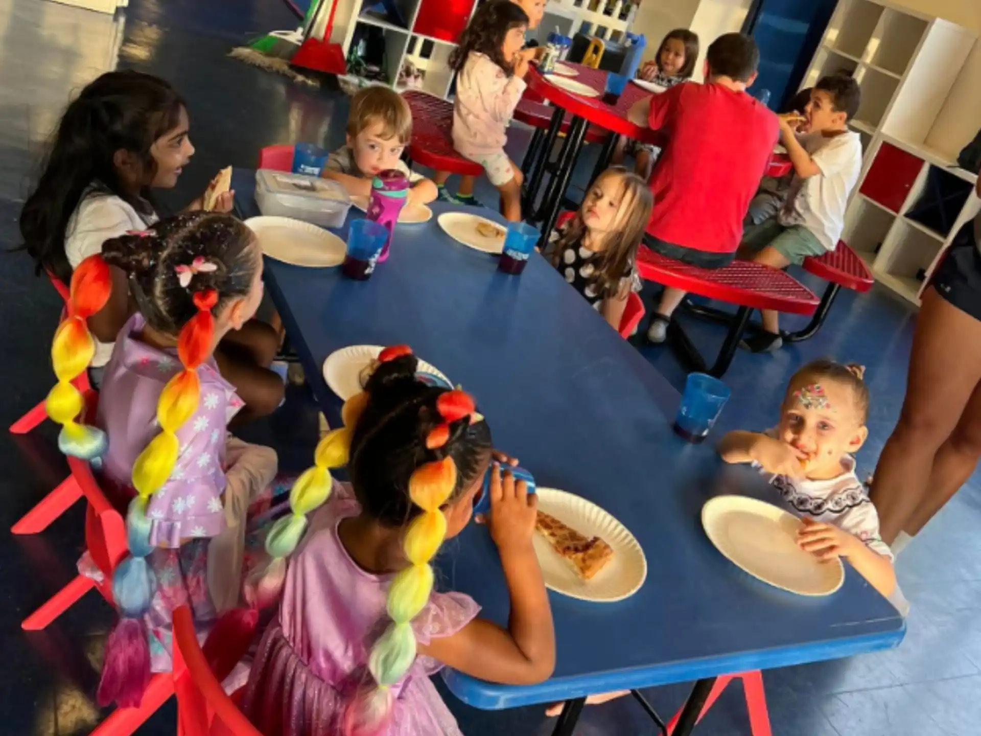 a group of children eating at a table