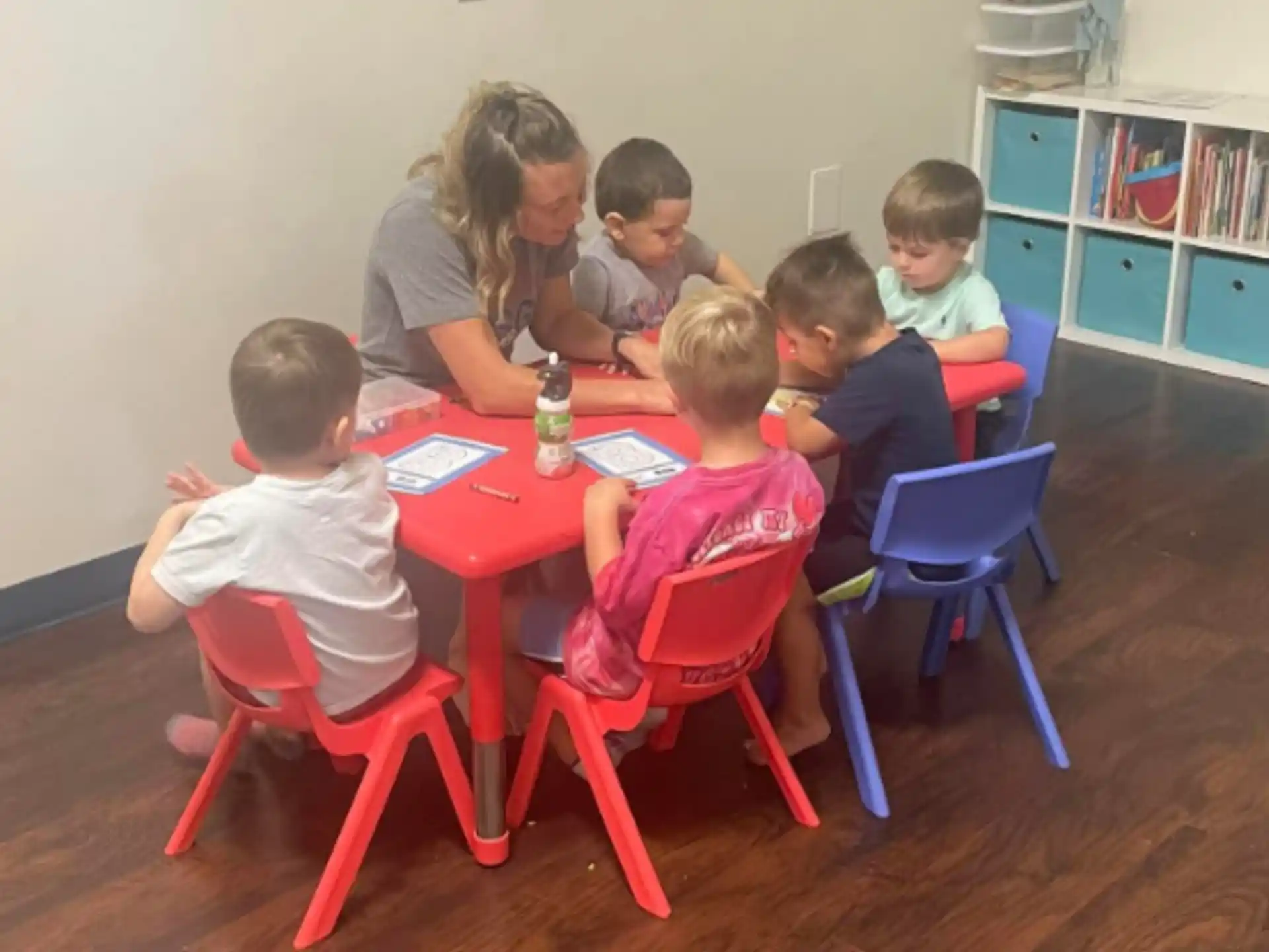 a group of children sitting around a table