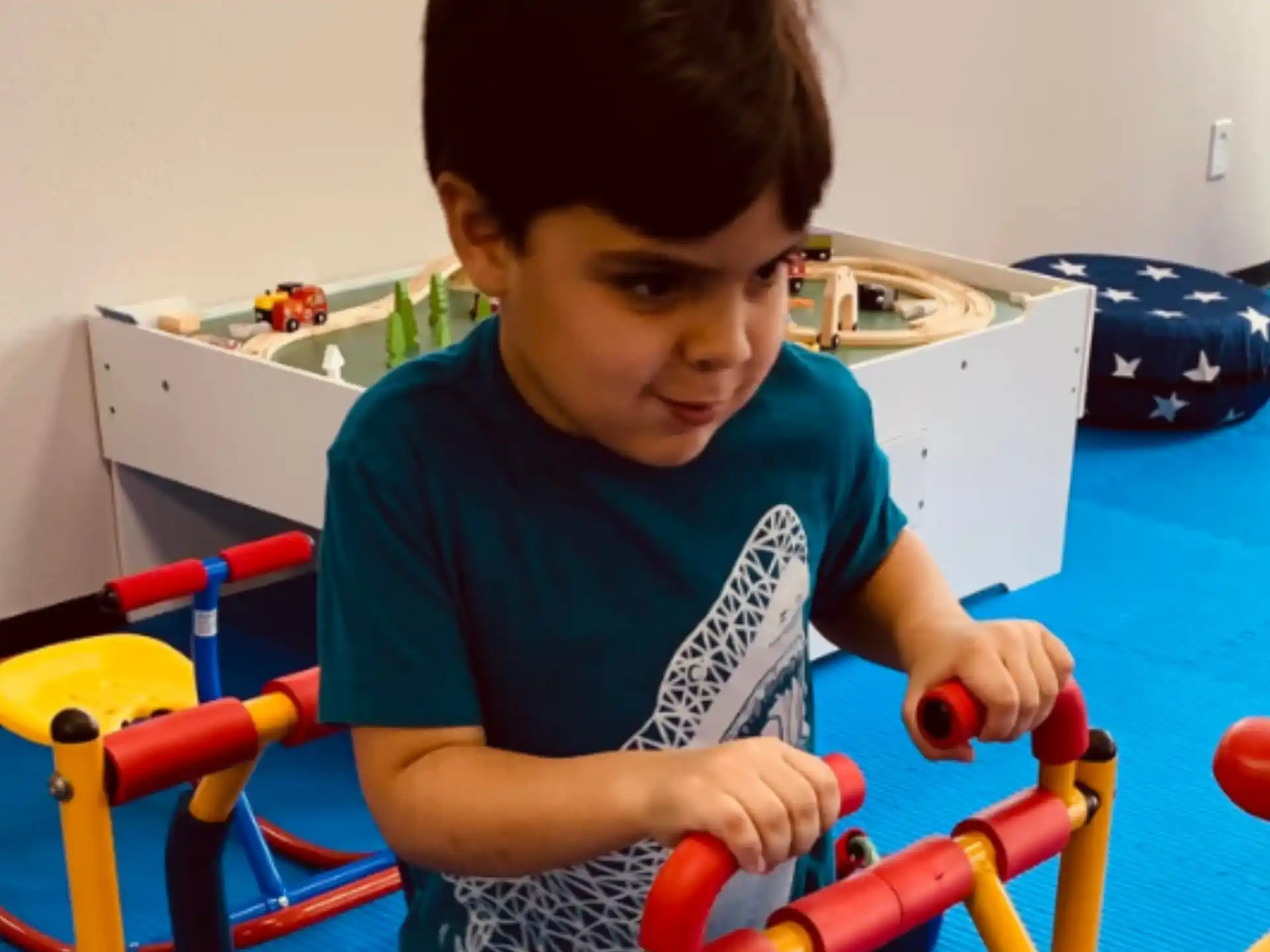 a boy holding a toy