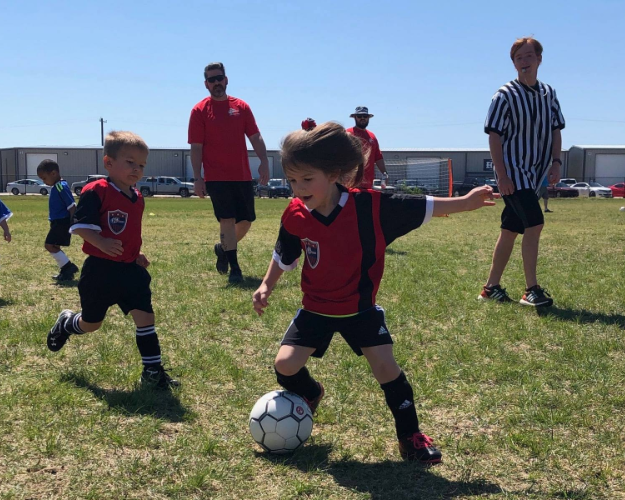 a group of kids playing football