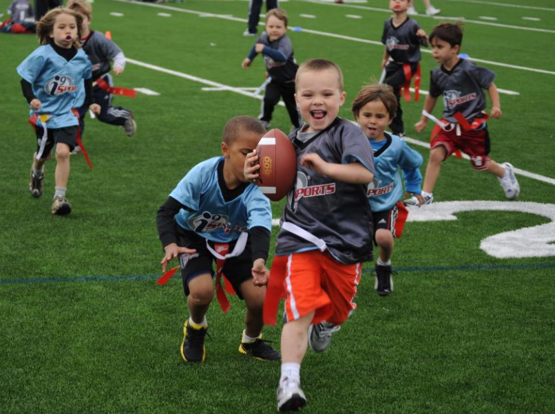 a group of kids playing football