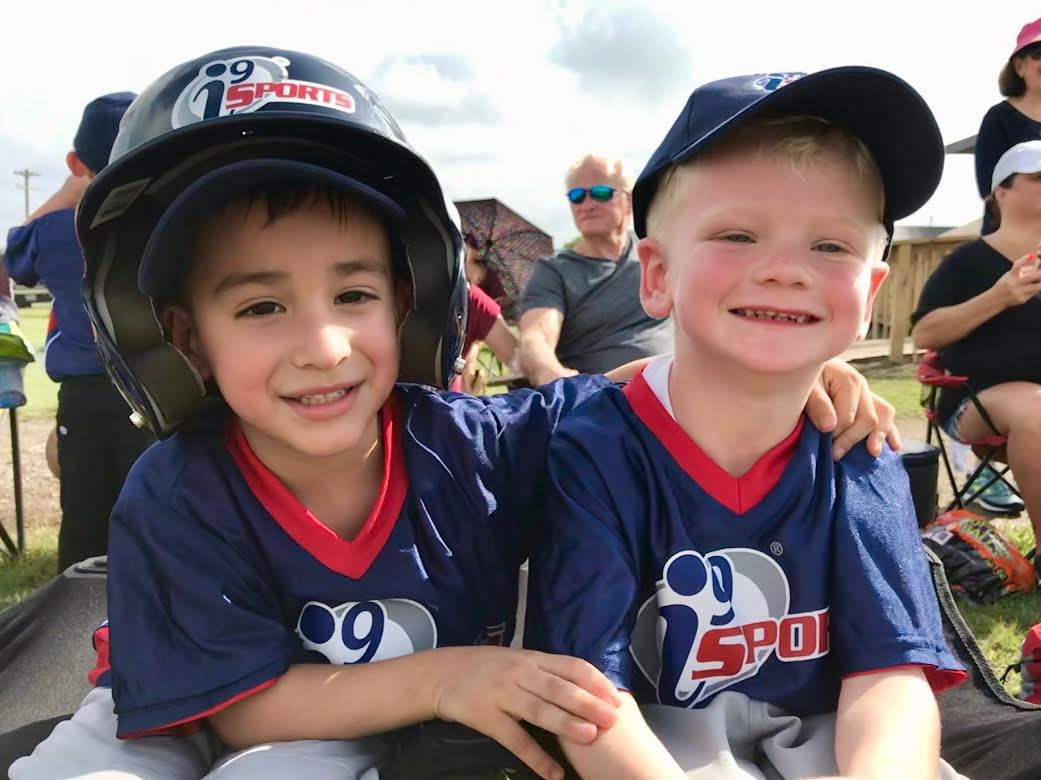 a couple of boys wearing helmets
