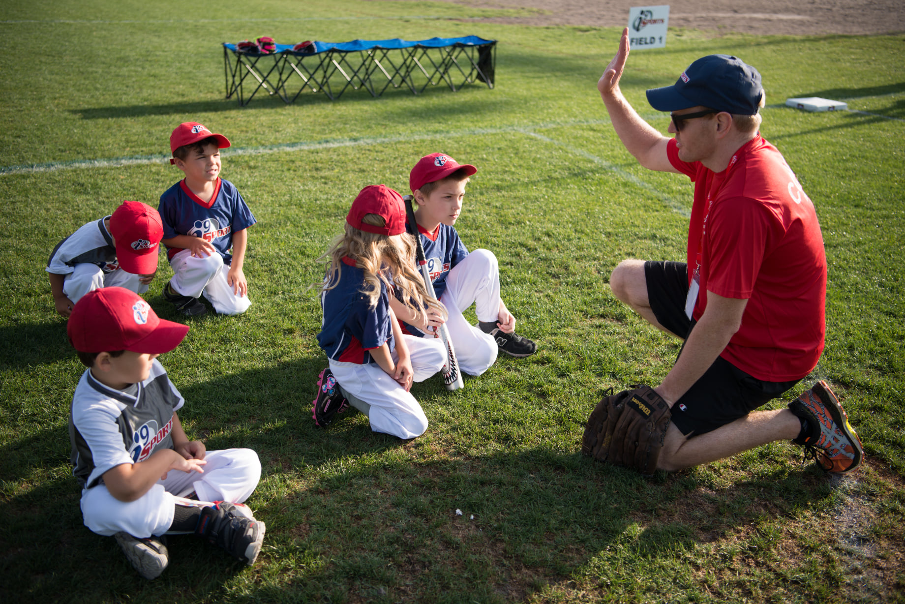 a group of kids sitting on the grass