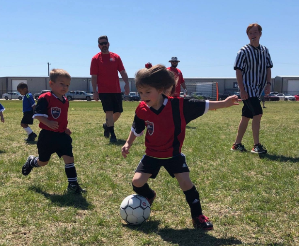 a group of kids playing football