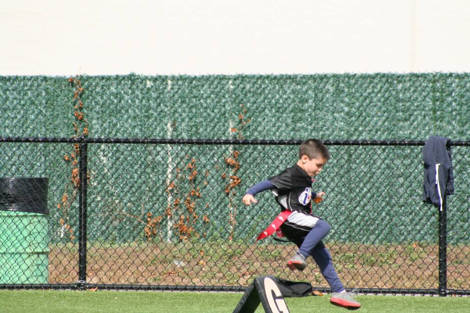 a boy running on a field