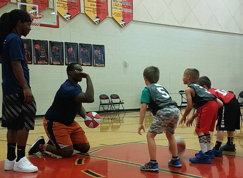 a group of kids playing basketball