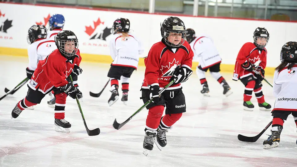 a group of people playing hockey