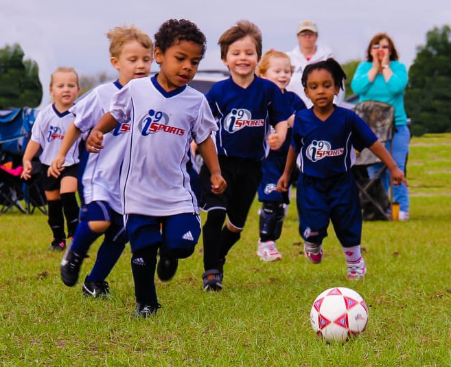a group of kids playing football