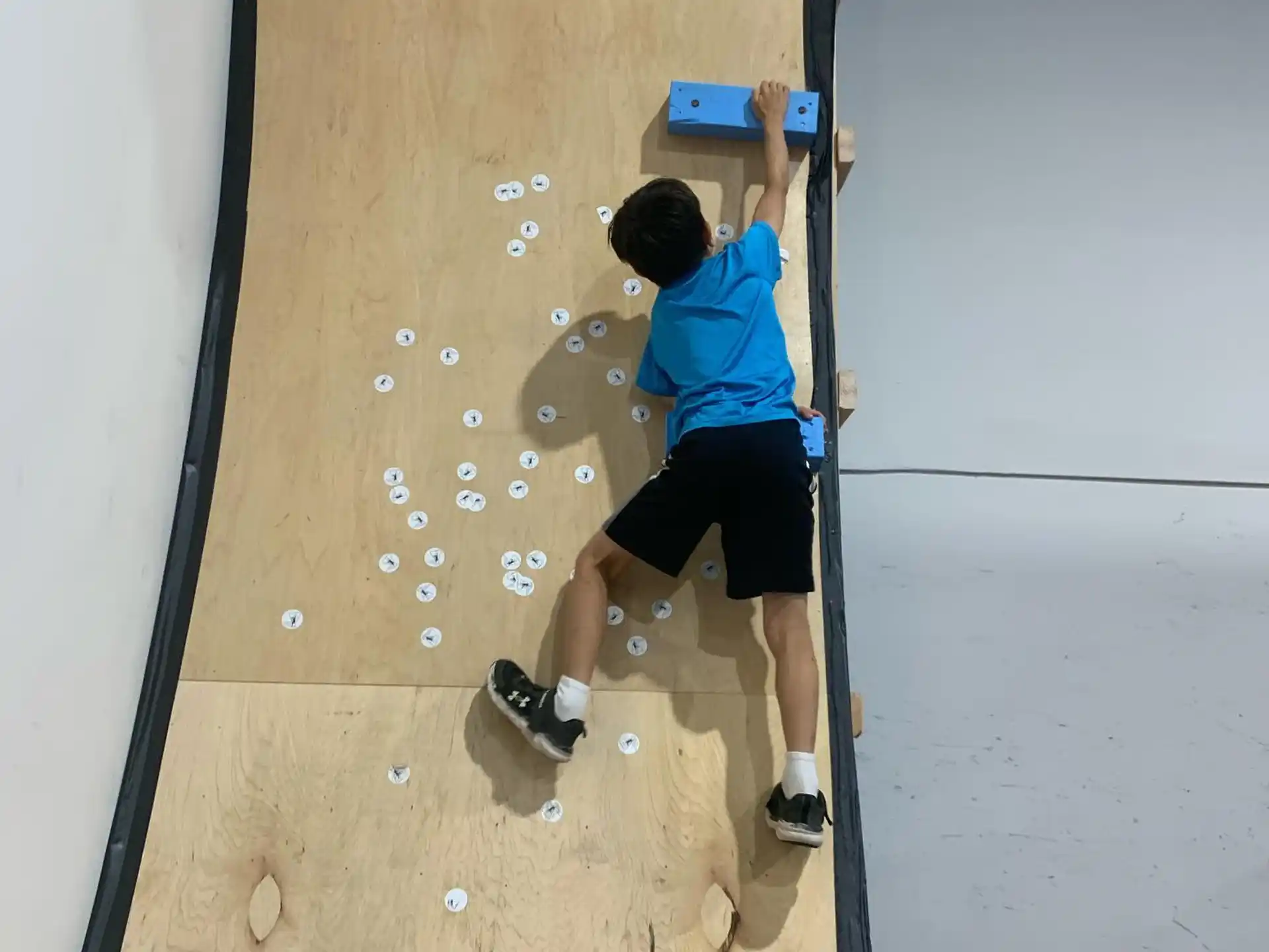 a boy climbing a wall