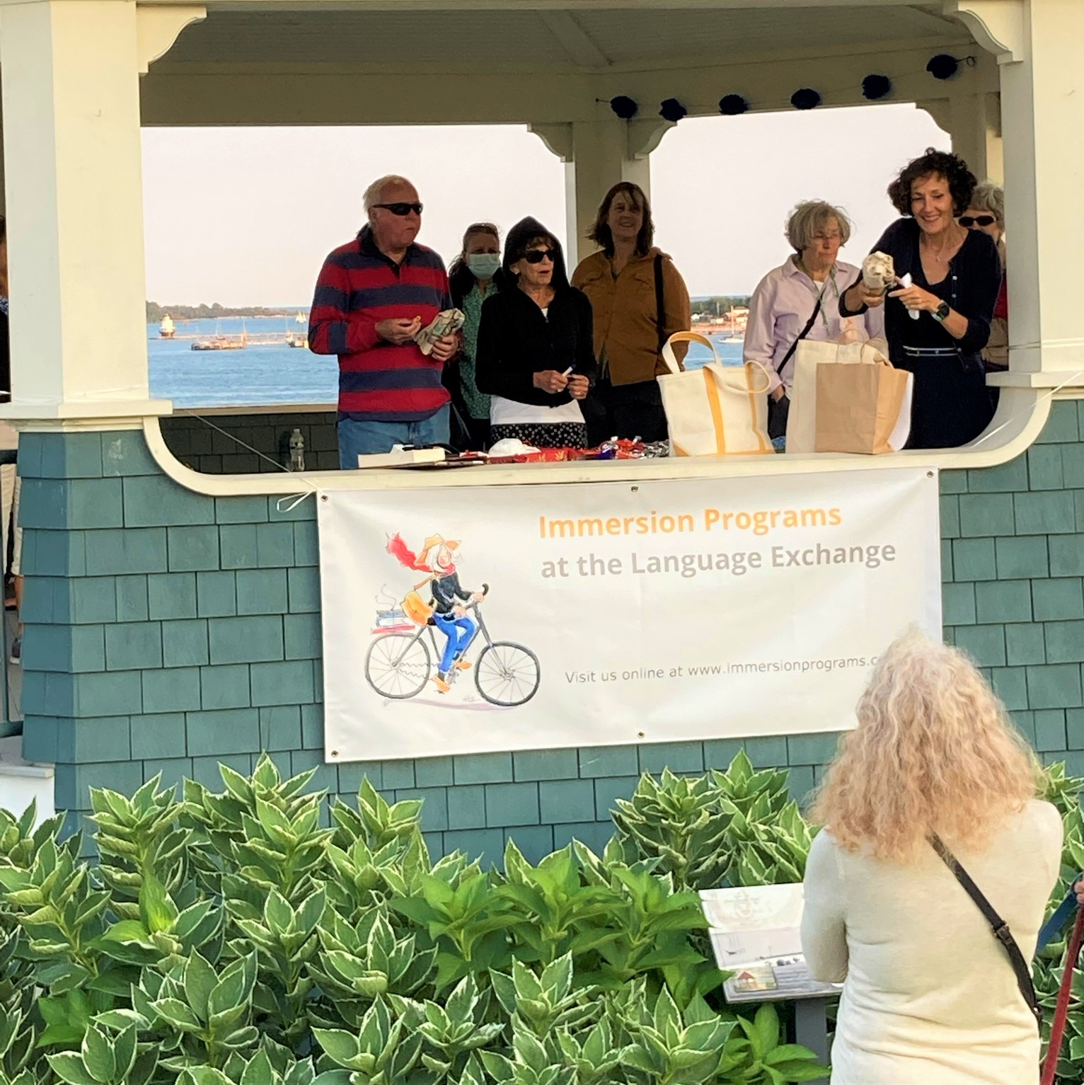a group of people standing around a sign