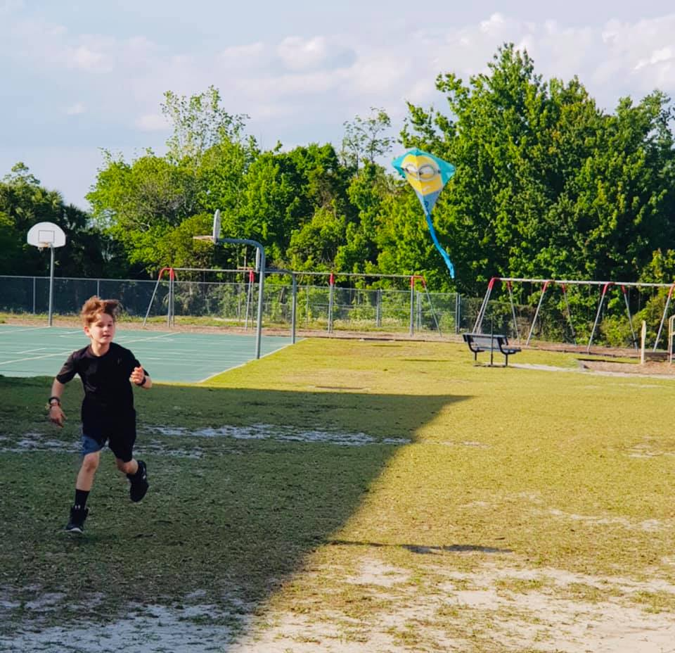 a boy running in a park