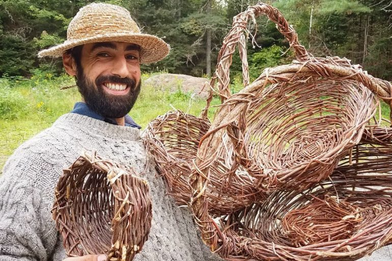 a man holding a bundle of straw
