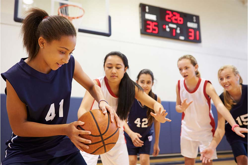 a group of women playing basketball
