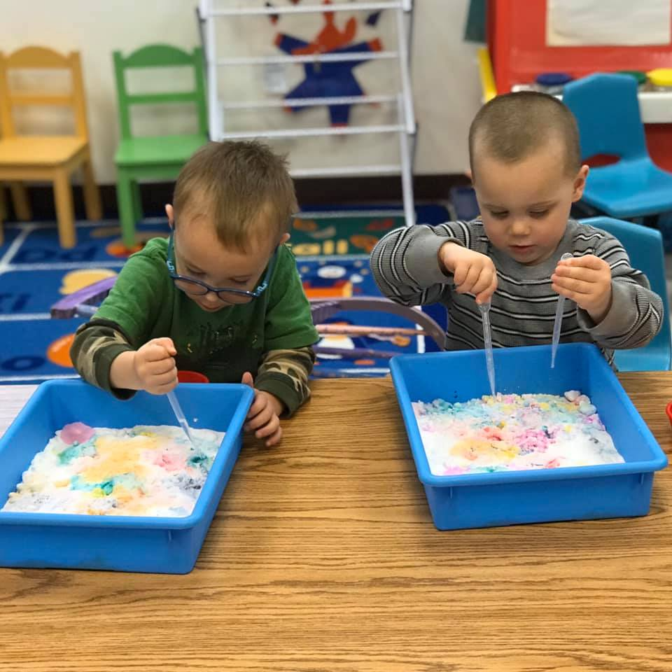 two boys playing with toys
