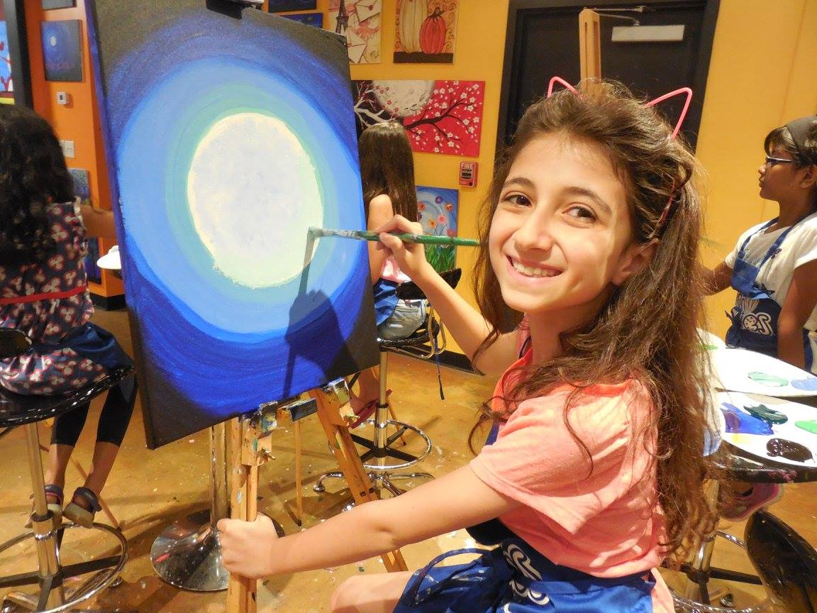 a girl holding a blue balloon