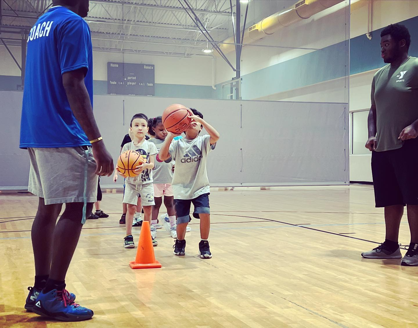a group of kids playing basketball
