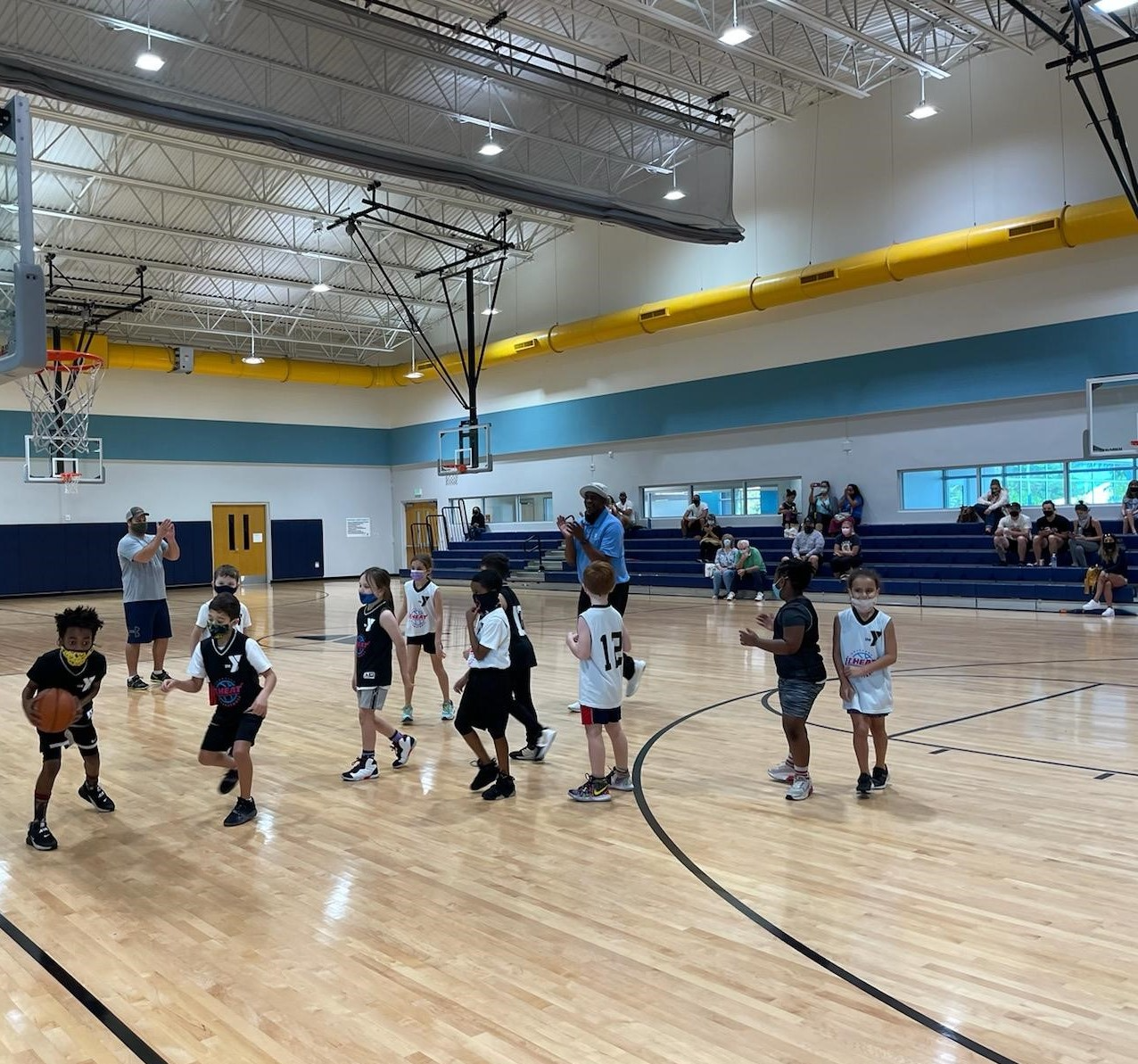 a group of people playing basketball
